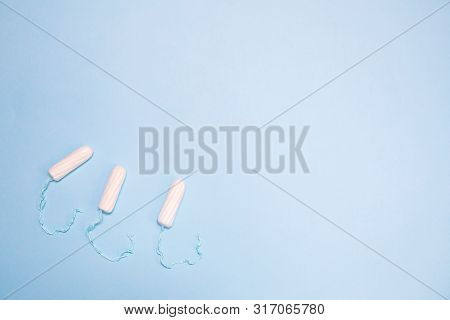 The Uncompressed Tampons White On A Blue Background, The Concept Of Women's Intimate Hygiene And Hea