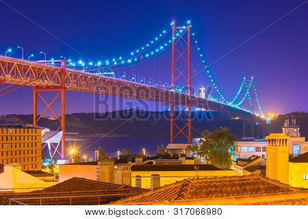 View Of The 25th April Bridge (ponte 25 De Abril) At Night, Lisbon, Portugal