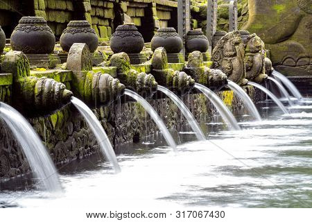 Praying In Holy Spring Water Of Sacred Pool At Pura Tirta Empul Temple, Tampaksiring