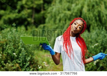 African Red Haired Volunteer Woman With Clipboard In Park. Africa Volunteering, Charity, People And