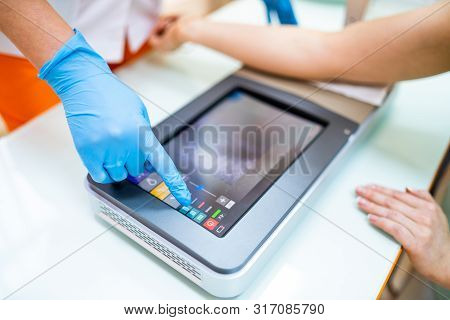 Medical Procedure. Woman Scanning Veins With Vein Finder