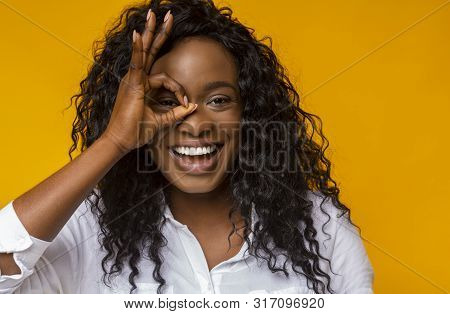 Life Is Good. Excited Black Girl Having Fun, Smiling And Covering One Eye With Okay Gesture, Copy Sp