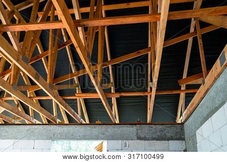Roof Trusses Covered With A Membrane On A Detached House Under Construction, Visible Roof Elements, 