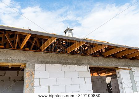 Roof Trusses Covered With A Membrane On A Detached House Under Construction, Visible Roof Elements, 