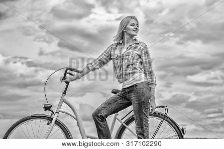 Active Leisure And Healthy Activity. Girl Ride Cruiser Model Bicycle. Woman Rides Bicycle Sky Backgr