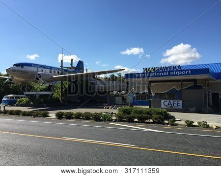 A Big Old Blue And White Prop Airliner In Place On The Side Of The Main Highway In New Zealand Used 