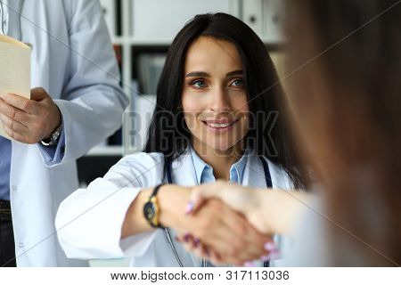 Beautiful Smiling Female Gp Shaking Hands With Visitor Portrait. Self Introduction Cheering And Supp