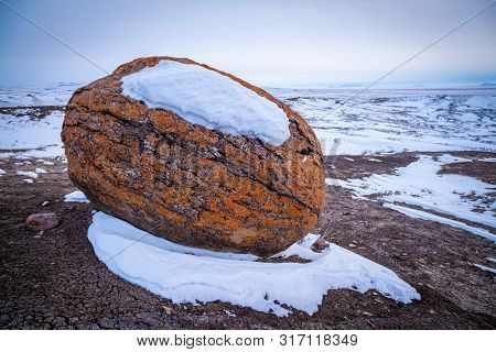 Large Red Boulders At Red Rock Coulee, Alberta, Canada In The Evening On A Cold Winter Day