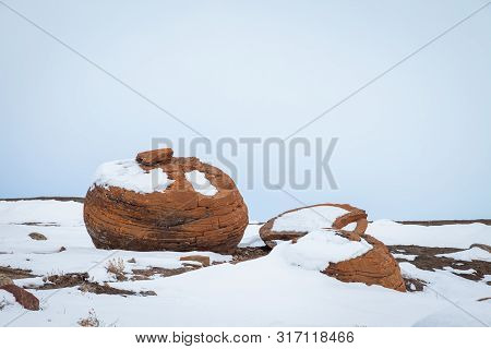 Large Red Boulders At Red Rock Coulee, Alberta, Canada In The Evening On A Cold Winter Day