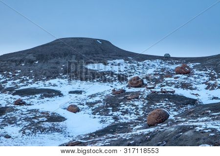 Large Red Boulders At Red Rock Coulee, Alberta, Canada In The Evening On A Cold Winter Day