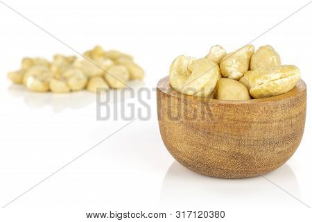 Lot Of Whole Unsalted Beige Cashew Small Group Behind In Tiny Wooden Bowl Isolated On White Backgrou