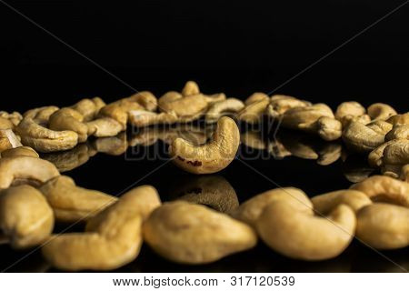 Lot Of Whole Unsalted Beige Cashew One In Circle Isolated On Black Glass