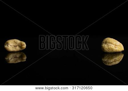 Group Of Two Whole Unsalted Beige Cashew Isolated On Black Glass