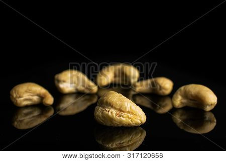 Group Of Six Whole Unsalted Beige Cashew Isolated On Black Glass