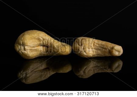 Group Of Two Whole Unsalted Beige Cashew Isolated On Black Glass