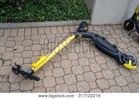 Arlington, Virginia - August 7, 2019: A Bolt Brand Dockless Scooter Is Dumped And Fallen Over On A S