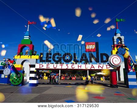 Entrance Gate To The Legoland Amusement Park In GÃ¼nzburg, Germany.fireworks At Daytime Above The En