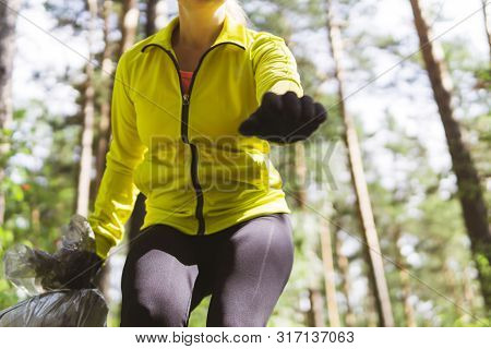 Female Jogger Leans Over Trash During Plogging, Bottom View