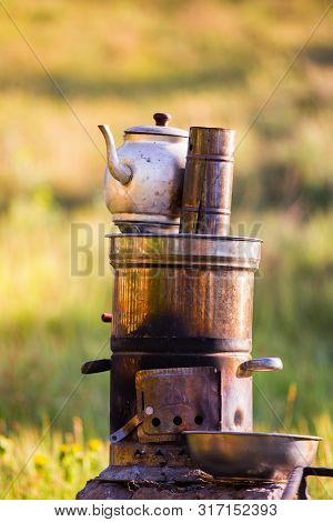 Turkish Samovar Outdoor. Preparing Tea Outside On The Nature On The Double Pot On The Fire.
