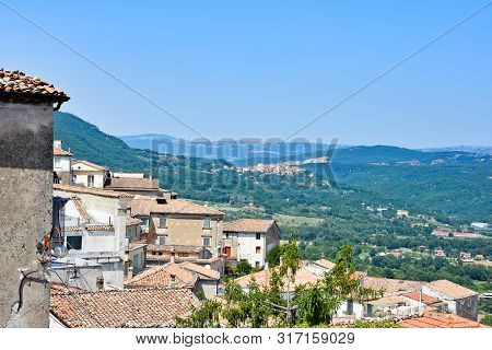 View Of A Tourist Town In Southern Italy, Among Hills And Woods