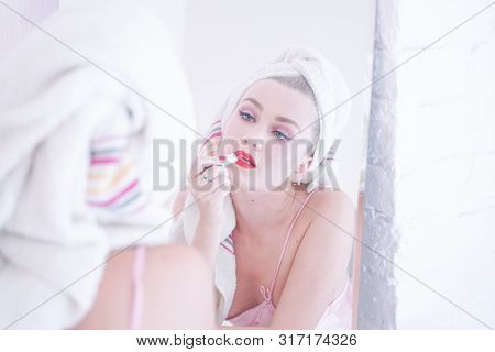 Attractive Young Woman Wrapped With Bath Towel After A Shower At The Bathroom.