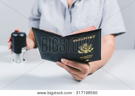 Immigration And Passport Control At The Airport. Woman Border Control Officer Puts A Stamp In The Us
