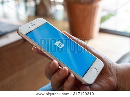Chiang Mai, Thailand - Apr.27,2019: Woman Holding Apple Iphone 6s Rose Gold With Linkedin Applicatio
