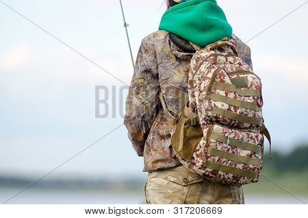 Road Tactical Backpack Coloring Worn On The Back Of The Yakut Girls-tourist Angler Catches A Fish In