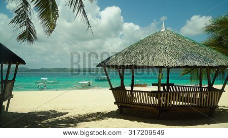 Bungalow On A Tropical Beach With Palm Trees And Blue Sea Of Daco, Philippines. Summer And Travel Va