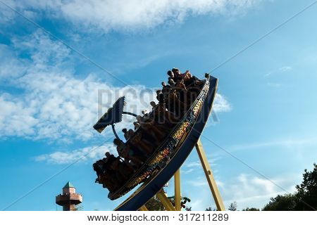 Kouvola, Finland - 10 August 2019: Silhouette Of Ride Trombi In Motion On Sky Background In Amusemen