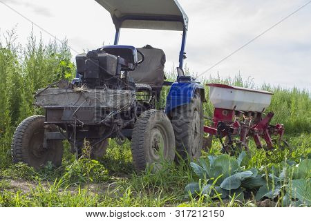 Macro Photo Transport Retro Vintage Tractor. Texture Background Blue Tractor With Trailer. Rural Old