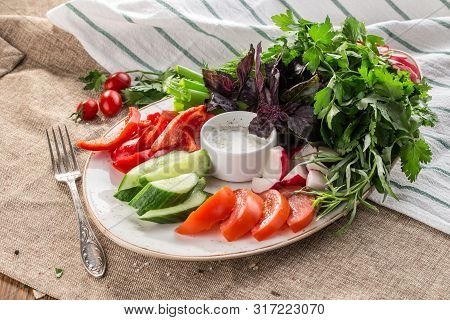 Plate With Fresh Vegetable Sliced Salad With Cucumber, Tomato, Pepper And Basil, Parsley On Tablelco