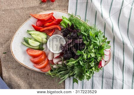 Plate With Fresh Vegetable Sliced Salad With Cucumber, Tomato, Pepper And Basil, Parsley On Tablelco