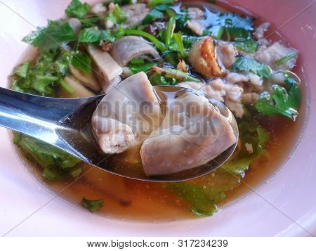 Thai Food Style, Selective Focus Of Chitterlings With Clear Soup And Offal Pork In Bowl As A Backgro