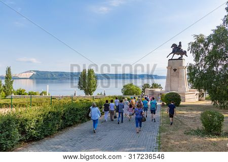 Togliatti, Samara Region / Russia - July 2, 2019: Tourists On The Background Of The Monument To The 