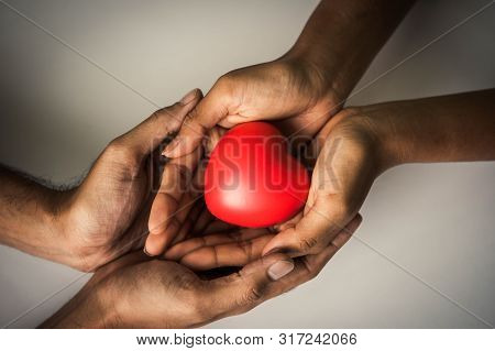 Helping Hand Of Heart Donor For Patient In Heart Disease. Man Give Red Heart To Woman As Couple. Peo