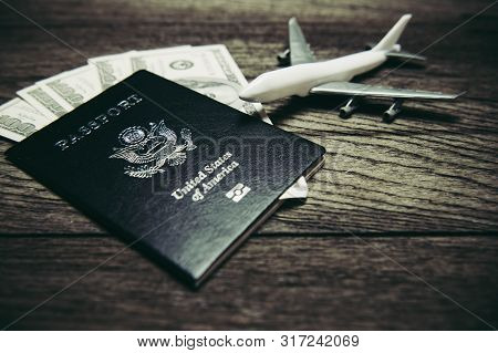 Top View Of Tourist Planning Props And Travel Accessories With American Passport, Airplane And Us Do