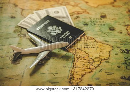 Top View Of Tourist Planning Props And Travel Accessories With American Passport, Airplane And Us Do