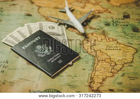 Top View Of Tourist Planning Props And Travel Accessories With American Passport, Airplane And Us Do