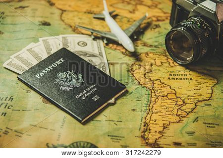 Tourist Planning Props And Travel Accessories With American Passport, Airplane, Digital Camera And U