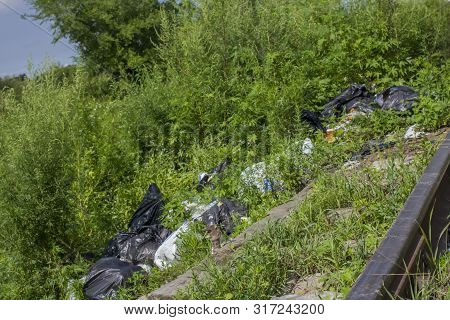 A Package With Garbage On The Railway Thrown Out From The Window Of The Train By Passengers, Polluti