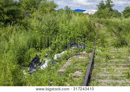 A Package With Garbage On The Railway Thrown Out From The Window Of The Train By Passengers, Polluti