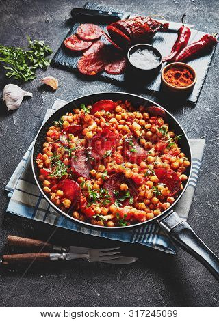 Close-up Of Garbanzos Fritos, Hot Chickpea Stew With Sliced Chorizo, Ham, Tomatoes And Spices In A S
