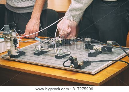 Engineers Connect Wires Control Panel With A Small Test Bench For Experiments