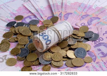 Ukrainian Banknotes Value Of 200 And 500 Hryvnia Uah And Pile Of Coins.
