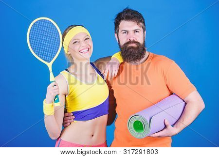 Sporty Couple Training With Fitness Mat And Tennis Racket. Sport Equipment. Athletic Success. Happy 