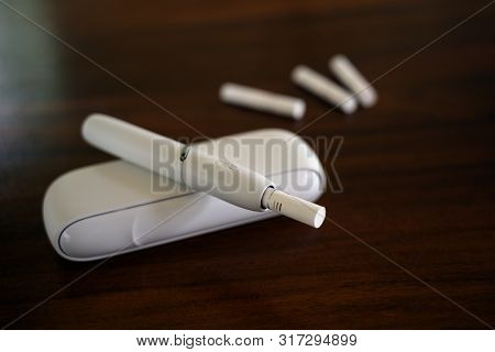 Rieps, Germany, August 15, 2019: Iqos Heating Tobacco System From Philip Morris On A Brown Table, An