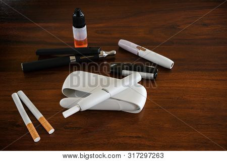 Different Smoke Systems In Comparison, Normal Cigarette, Tobacco Heater With Sticks And E-cigarette 