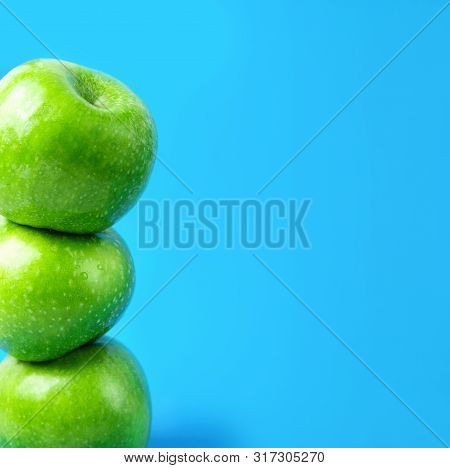 Stacked Ripe Green Organic Apples On Blue Background. Vegan Food Weight Loss Detox Vitamins Plant Ba