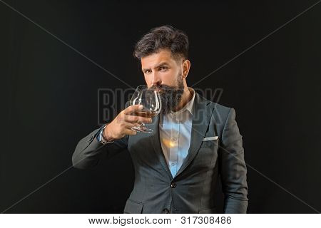 Alcohol Concept. Luxury Beverage Concept. Man Bartender With Beard Holds Glass Brandy. Fashion Style